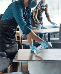 stock-photo-busy-young-male-waiters-in-protective-workwear-cleaning-tables-in-restaurant-1993611917-transformed-scaled